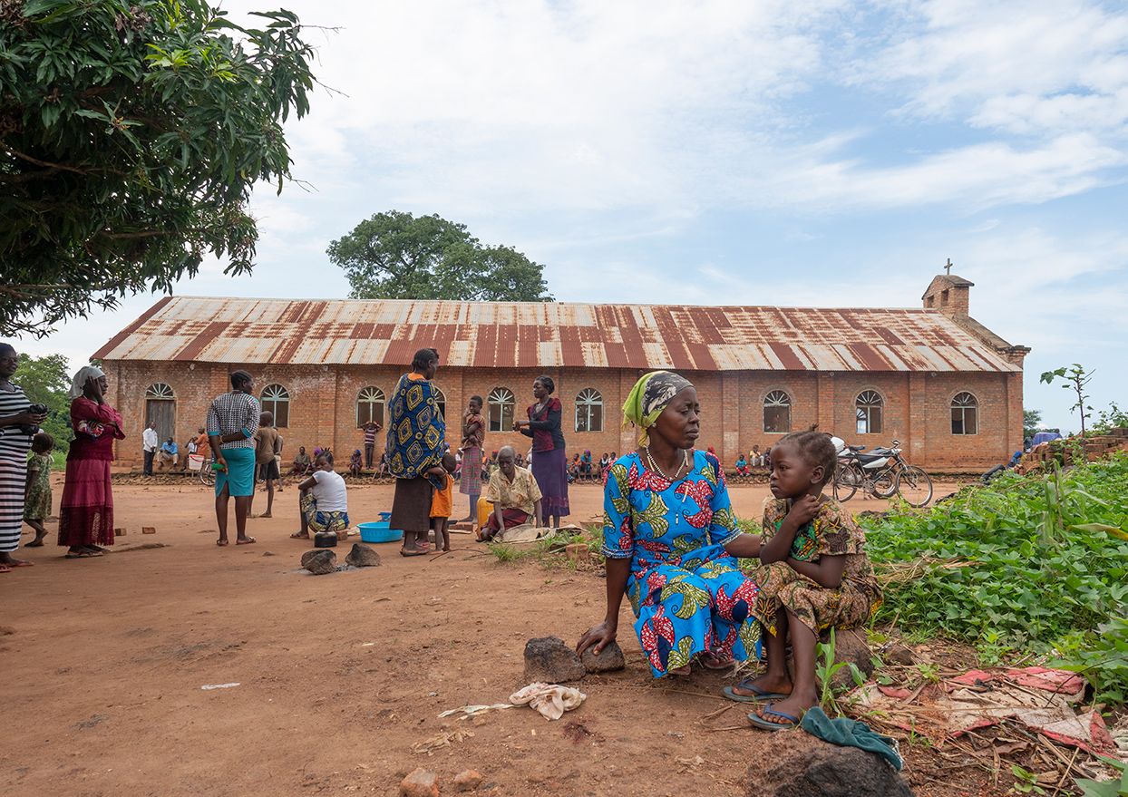 More than 7,500 people, many of them women and children, have settled in a field next to a church.
