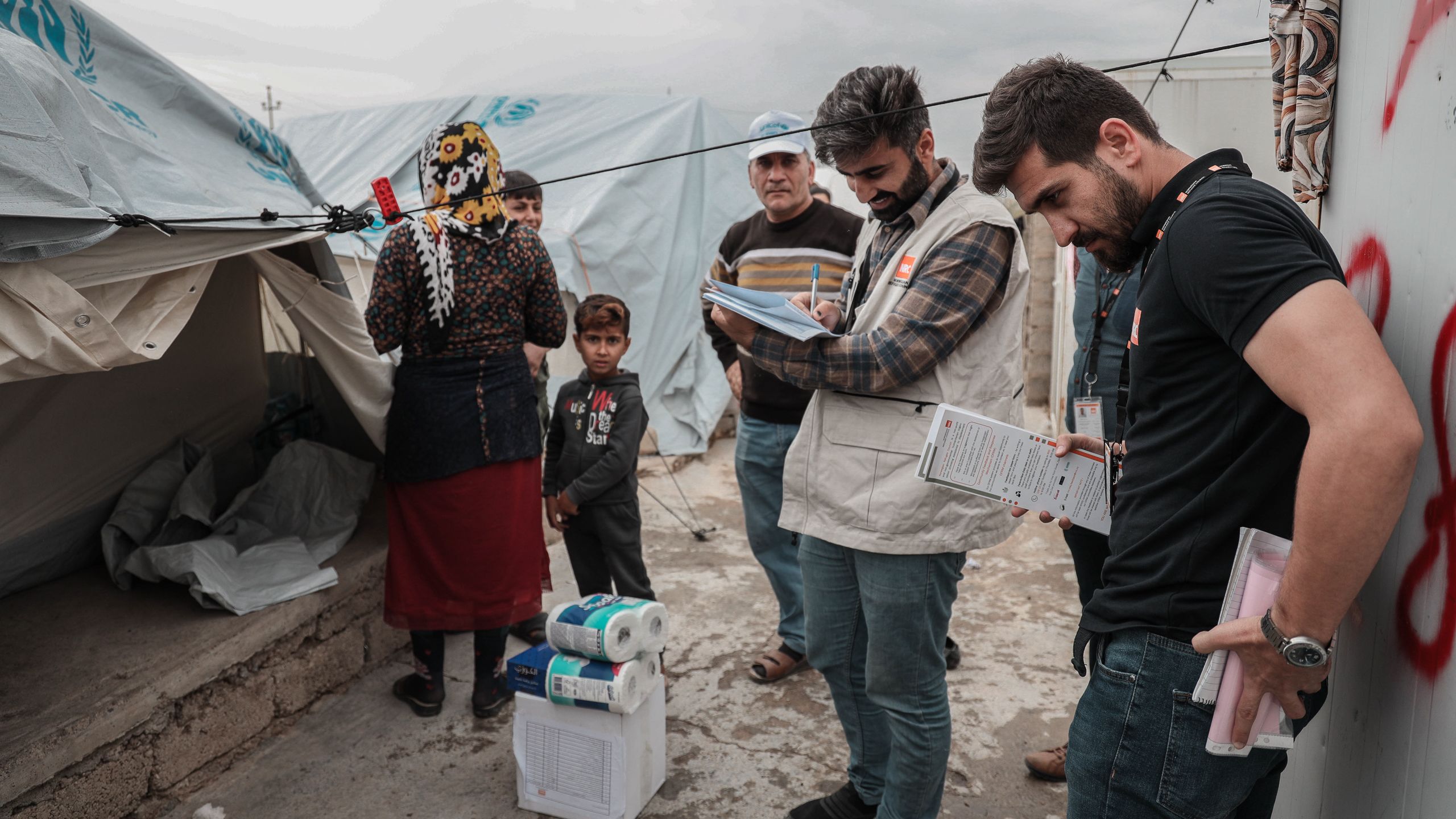 NRC staff registering and assessing the needs of new arrivals in Iraq, and distributing items soap, diapers and bottled water.